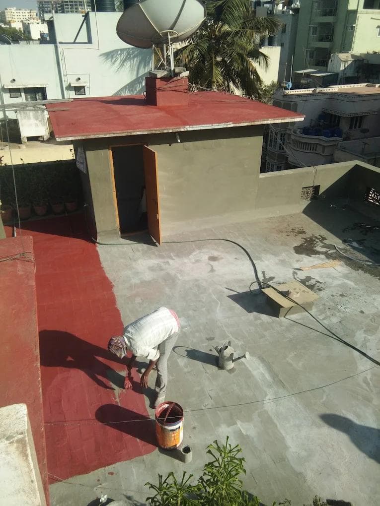 Workers applying waterproof coating